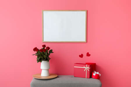Gifts for Valentine's Day and flowers on bench in room