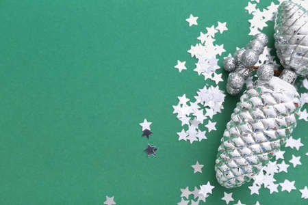 Beautiful confetti and Christmas toys on green background, closeupの写真素材