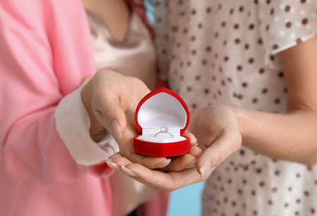 Young lesbian couple with engagement ring, closeup