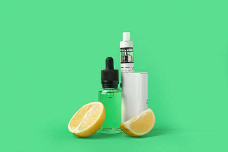 Modern vape mod, oil and lime on green backgroundの写真素材