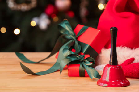 Christmas bell and gifts on tableの写真素材