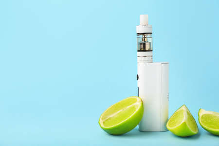 Modern vape mod and lime on blue backgroundの写真素材