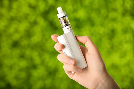 Female hand with modern vape mod outdoors, closeupの写真素材