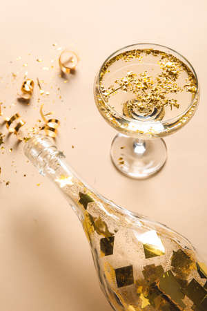Composition with glass of champagne, bottle and serpentine on color background, closeupの写真素材