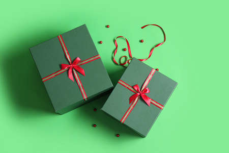 Beautiful Christmas gift boxes on green backgroundの写真素材