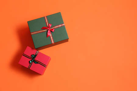 Beautiful Christmas gift boxes on orange backgroundの写真素材