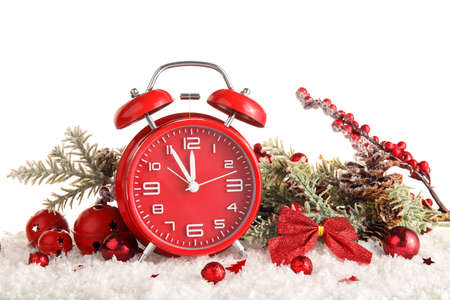 Beautiful composition with alarm clock, snow and Christmas decorations on white background