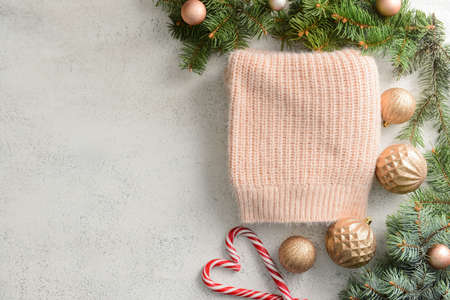 Composition with Christmas clothes, fir branches and decorations on light backgroundの写真素材