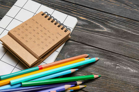 Craft calendar and stationery supplies on dark wooden background, closeupの写真素材