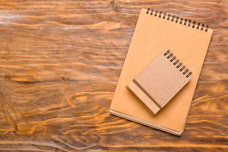 Blank craft calendar and notebook on wooden backgroundの写真素材