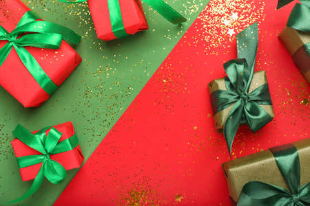 Many Christmas gifts on color backgroundの写真素材
