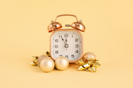 Alarm clock and Christmas balls on color backgroundの写真素材