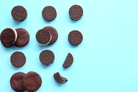 Tasty chocolate cookies with cream on blue backgroundの写真素材