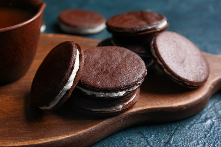 Board with tasty chocolate cookies on dark background, closeupの写真素材