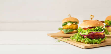 Different tasty vegetarian burgers on the table. banner designの写真素材