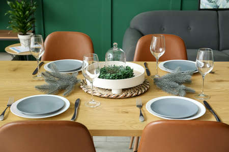 Beautiful dining table in room decorated for Christmas