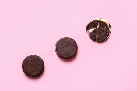 Tasty chocolate cookies with cream on pink backgroundの写真素材