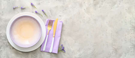 Beautiful table setting with flowers on light grunge background with space for textの写真素材