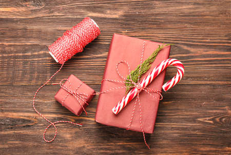 Christmas gifts decorated with candy cane and rope on wooden backgroundの写真素材