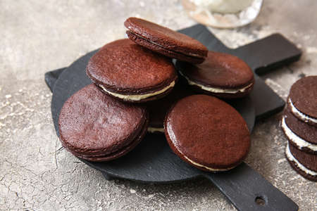 Slate board with tasty chocolate cookies on gray background, closeupの写真素材