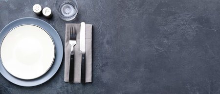 Simple table setting on gray background with space for textの写真素材