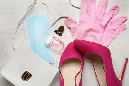 Female bag, shoes, medical mask, antiseptic and gloves on light backgroundの写真素材