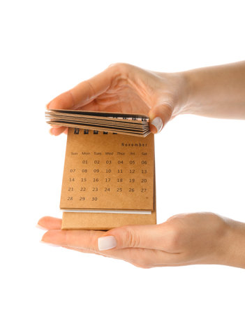 Woman holding craft calendar on white backgroundの写真素材