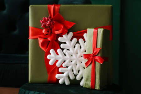 Gift boxes and big snowflake on pouf in roomの写真素材