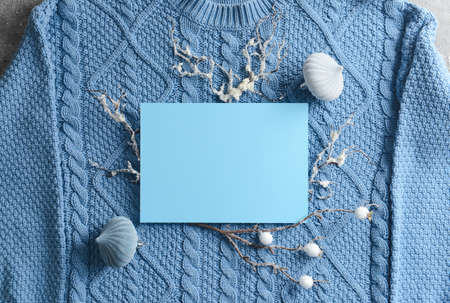 Blank card and Christmas decor on knitted sweaterの写真素材