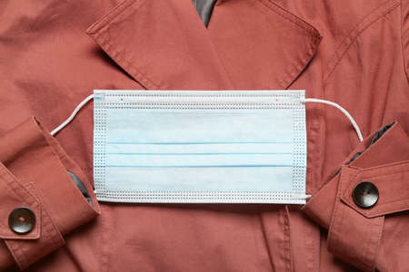 Medical mask on stylish female coatの写真素材