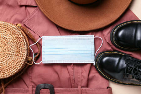 Female accessories, shoes and medical mask on stylish coatの写真素材