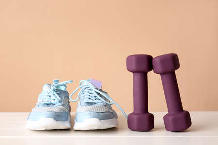 Stylish sport equipment on table against color wallの写真素材