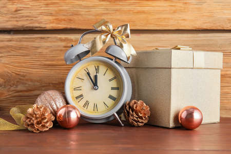 Stylish New Year clock and Christmas decor on table