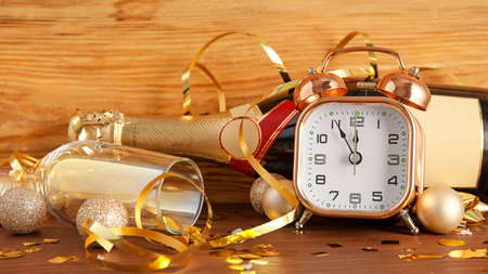 Stylish New Year clock and Christmas decor on tableの写真素材