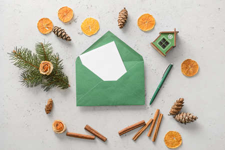 Composition with envelope, card, cinnamon and decor on light backgroundの写真素材