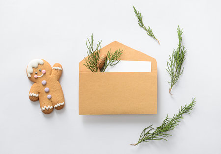 Composition with envelope, card, coniferous branches and cookie on white backgroundの写真素材