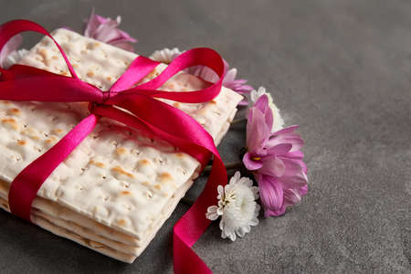 Jewish flatbread with flowers on grunge background