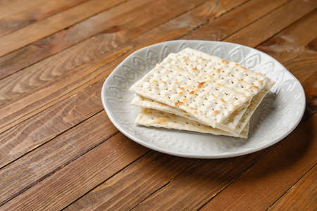 Plate with Jewish flatbread for Passover on wooden backgroundの写真素材