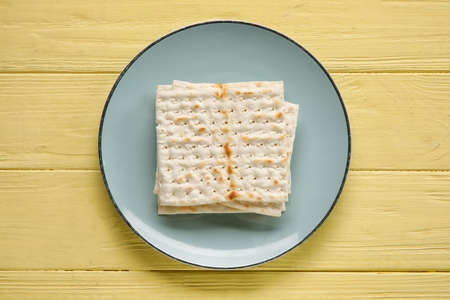 Plate with Jewish flatbread for Passover on color wooden backgroundの写真素材