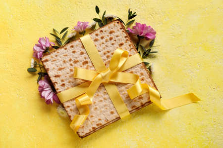 Jewish flatbread with flowers on color backgroundの写真素材