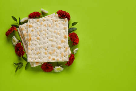 Jewish flatbread with flowers on color backgroundの写真素材
