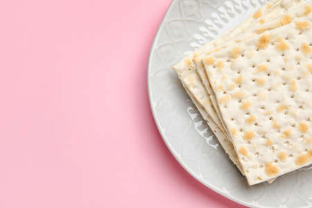 Plate with Jewish flatbread for Passover on color backgroundの写真素材