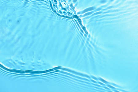 Texture of water with ripples on blue background, closeupの写真素材