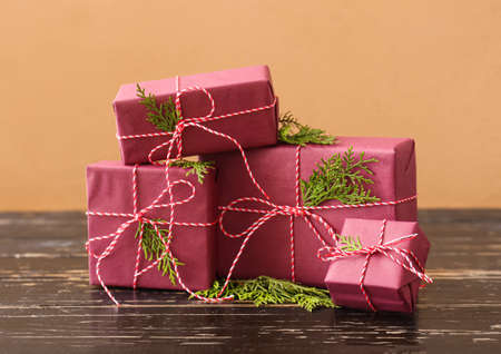 Christmas gift boxes and fir branches on dark wooden table