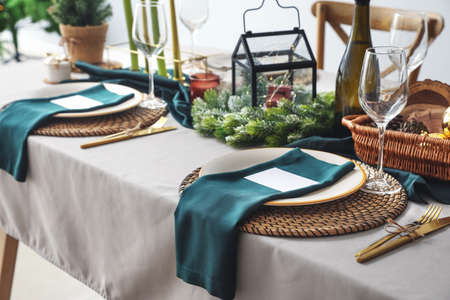 Festive table setting for Christmas celebration in dining roomの写真素材