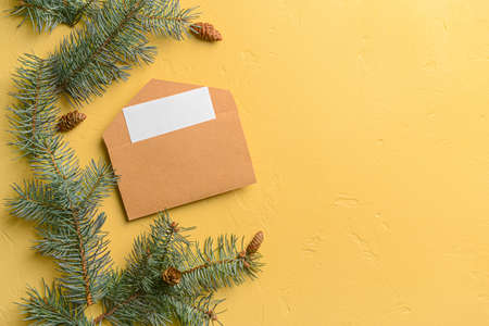 Envelope with Christmas branches on color backgroundの写真素材