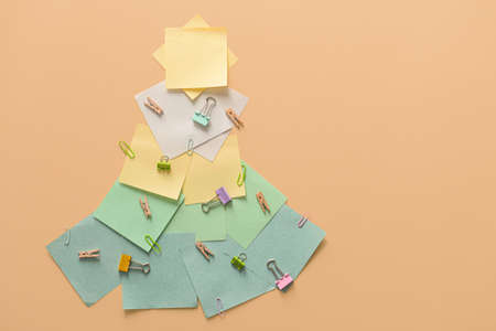 Christmas tree made of office stationery on color backgroundの写真素材