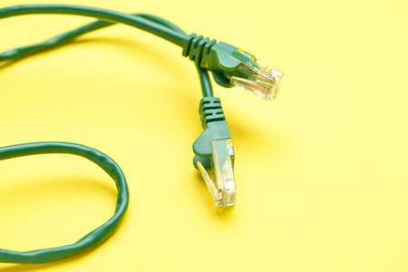 Modern internet cable on yellow background, closeupの写真素材