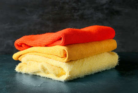 Stack of soft modern sweaters on dark backgroundの写真素材