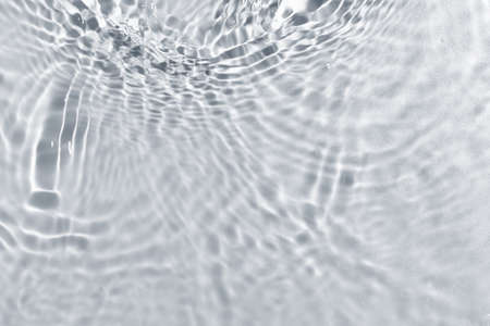 Texture of water with ripples on light background, closeupの写真素材